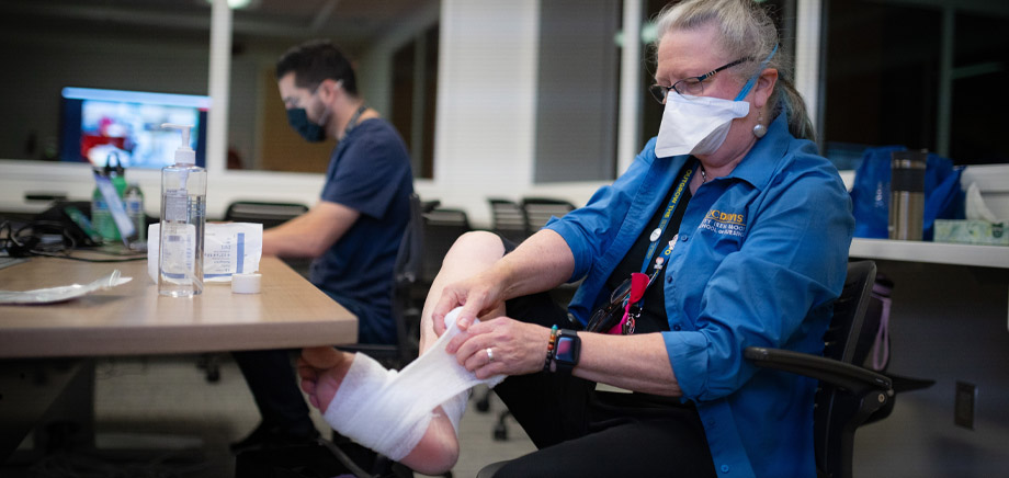 faculty sits in simulation observation room